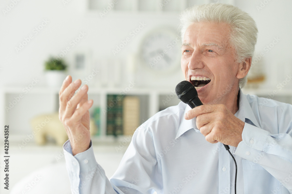Portrait of senior man singing with microphone Portrait of senior man singing with microphone