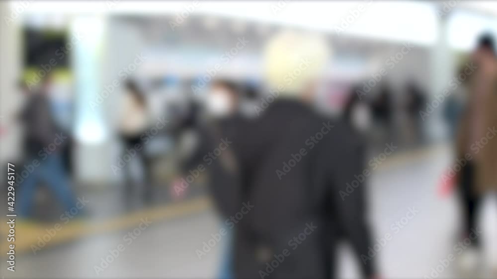 Blurred shot of people with mask walking through Hiroshima station in Japan. 4K. March 22, 2021 Blurred shot of people with mask walking through Hiroshima station in Japan. 4K. March 22, 2021