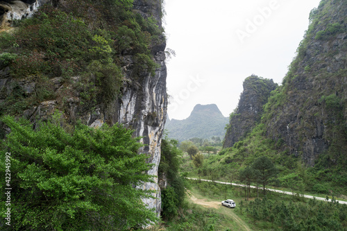 Aerail view of  offroad car on spring trail in mountains photo