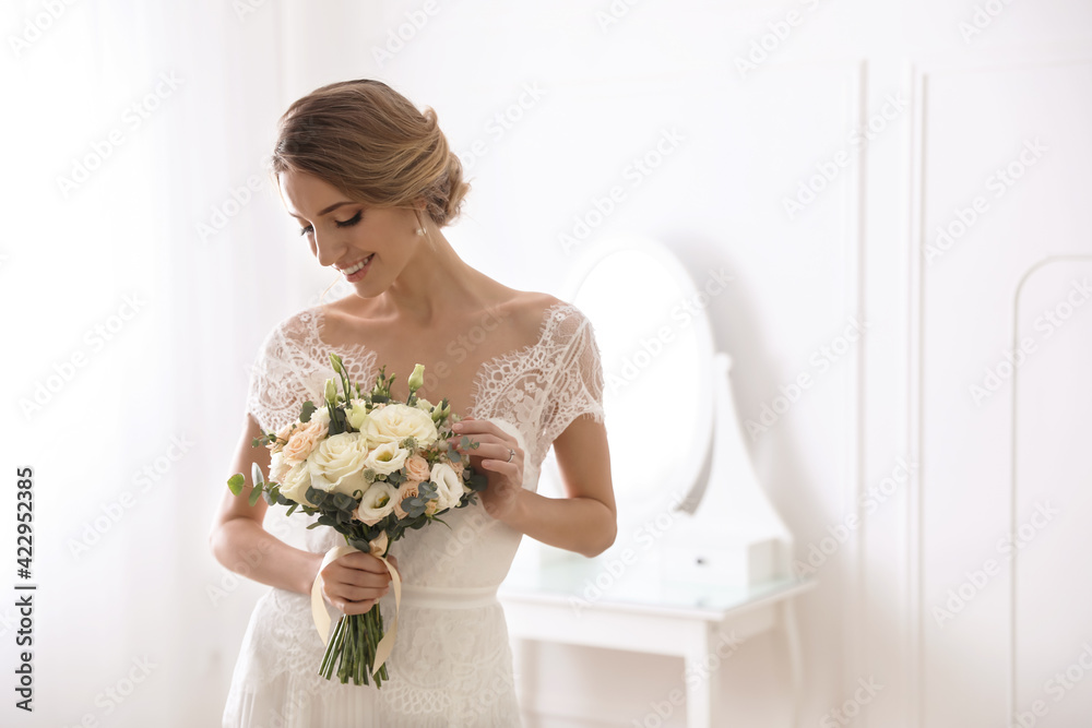 Bride in beautiful wedding dress with bouquet indoors. Space for text Bride in beautiful wedding dress with bouquet indoors. Space for text