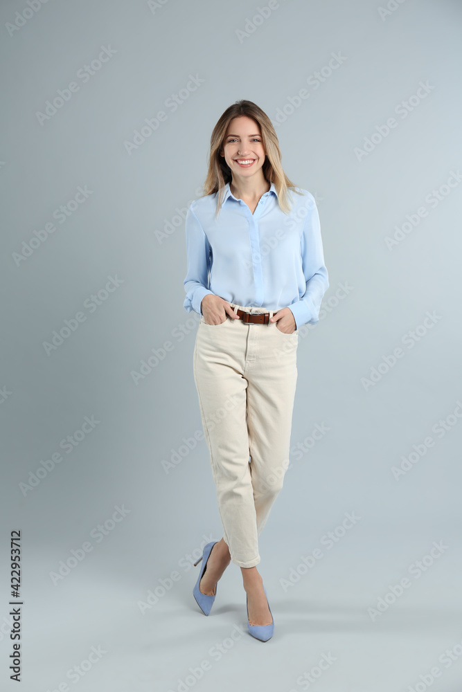 Full length portrait of beautiful young businesswoman on light grey background Full length portrait of beautiful young businesswoman on light grey background