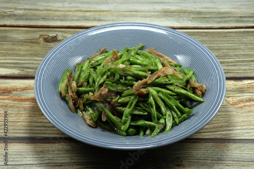 Traditional fried and stirred sliced green bean  Yardlong bean  mixed with chopped chicken serving on the plate. 