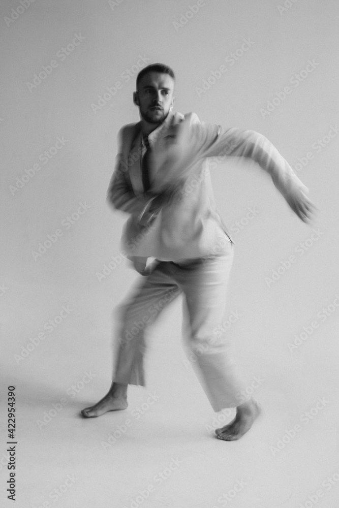 Portrait of a dancing guy with blurred background and long exposure. Black and white photography Portrait of a dancing guy with blurred background and long exposure. Black and white photography