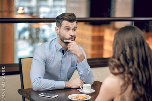 Man and woman having a blind date and looking disappointed photo