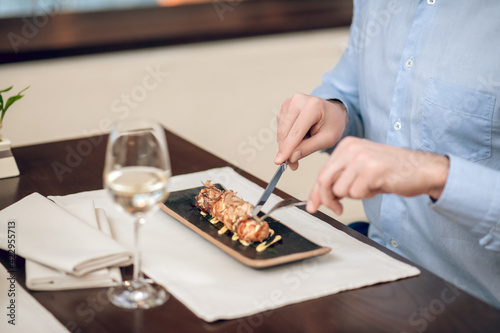 Close up of a man eating seafood at the restaurant
