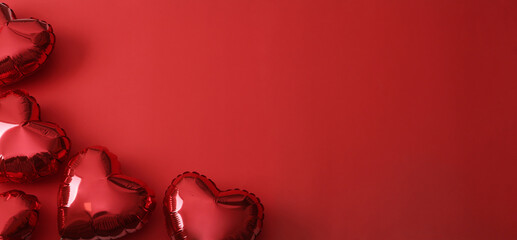 Heart shaped balloons on red background, flat lay with space for text. Saint Valentine's day celebration