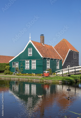 Traditional dutch wooden house and white bridge in Zaanse Schans, Netherlands