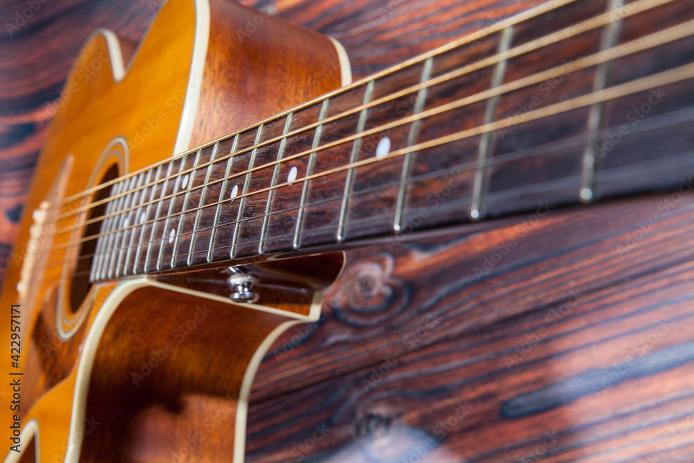 Close up of acoustic guitar. Acoustic guitar and an old wooden background Close up of acoustic guitar. Acoustic guitar and an old wooden background