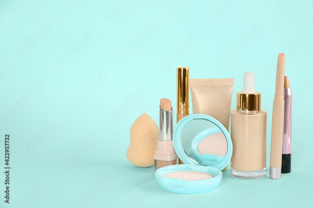 Foundation makeup products on turquoise background, space for text. Decorative cosmetics Foundation makeup products on turquoise background, space for text. Decorative cosmetics