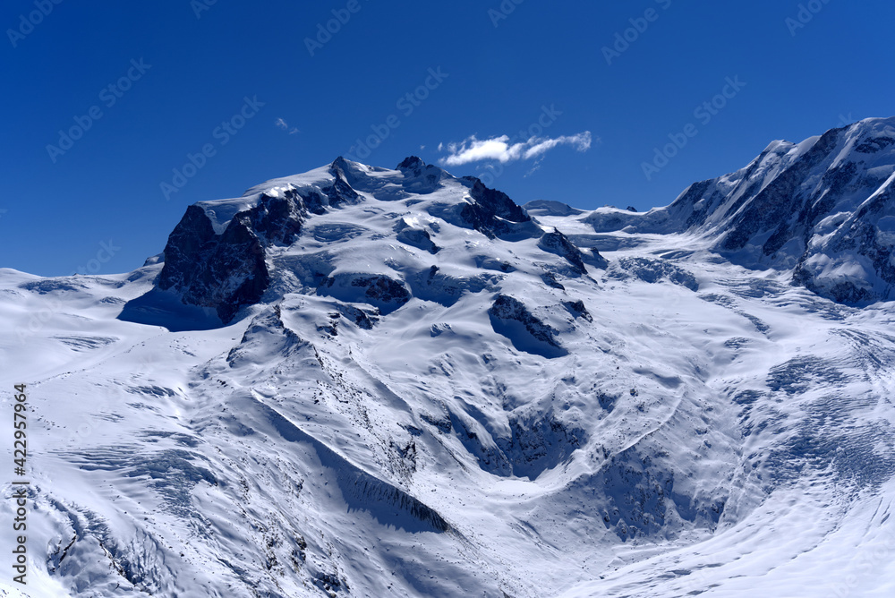 Snow capped mountains, snowfields and glaciers at Zermatt, Switzerland, seen from Gornergrat railway station.