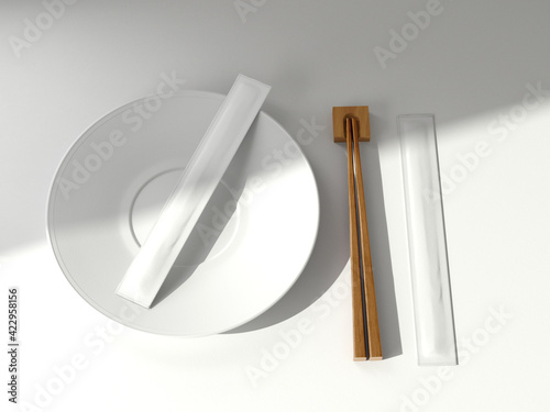 Two Plain White Chopsticks Packaging on Plate with wooden chopsticks on isolated background photo