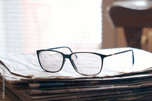 glasses on a newspaper closeup 
