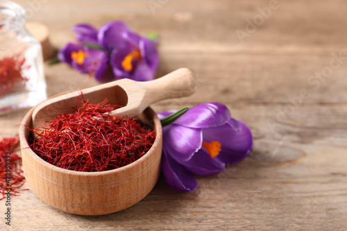 Canvas Print Dried saffron and crocus flowers on wooden table. Space for text