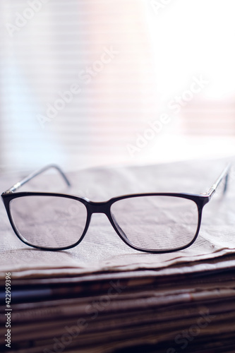 glasses on a newspaper closeup 