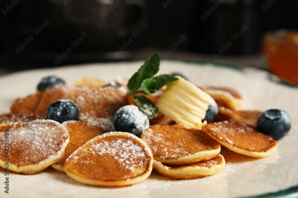 Cereal pancakes with blueberries and butter on plate, closeup Cereal pancakes with blueberries and butter on plate, closeup