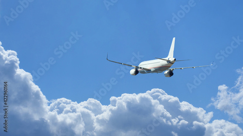 Ultra wide zoom photo of passenger airplane taking off in deep blue sky and beautiful clouds