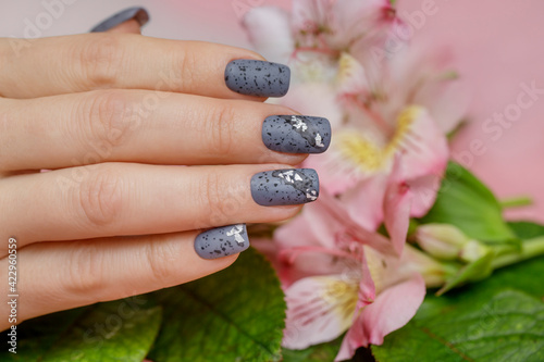 Female manicure with fantasy design on the background of pink colors. .