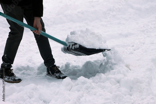 Man shoveling snow outdoors, cropped