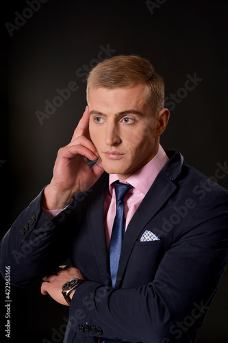 Portrait of young businessman posing in studio