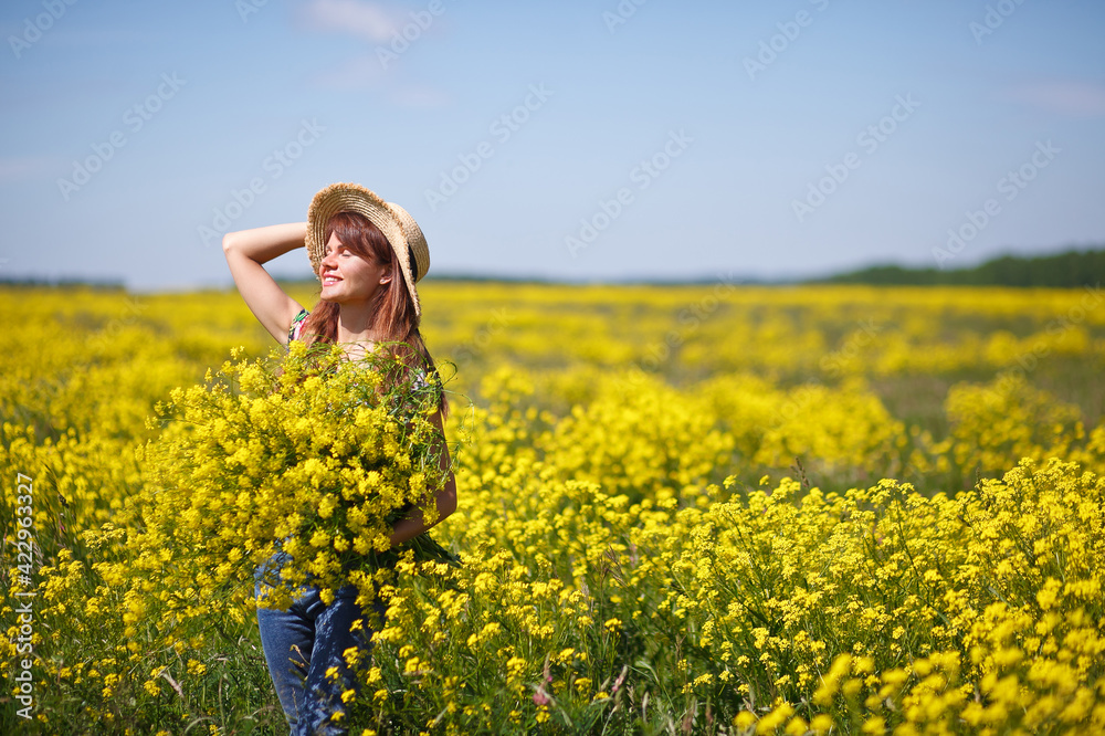 Young, beautiful woman in rapeseed field in the summer. Rural scene with attractive girl in hat enjoying sun in yellow blooming field. Concept of joy, happiness and freedom. Young, beautiful woman in rapeseed field in the summer. Rural scene with attractive girl in hat enjoying sun in yellow blooming field. Concept of joy, happiness and freedom.