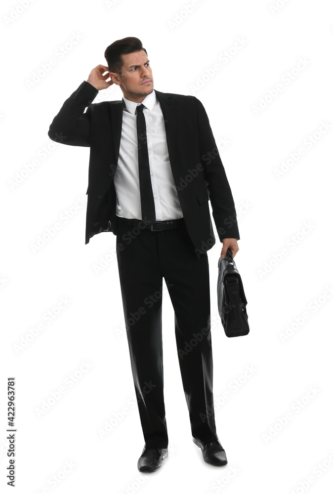 Thoughtful businessman with suitcase on white background