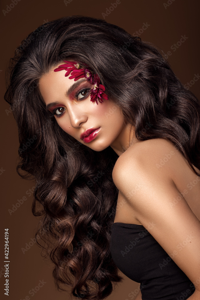 Brunette girl with long , healthy and shiny curly hair . Beautiful model woman with wavy hairstyle .Care and beauty gorgeous makeup Brunette girl with long , healthy and shiny curly hair . Beautiful model woman with wavy hairstyle .Care and beauty gorgeous makeup