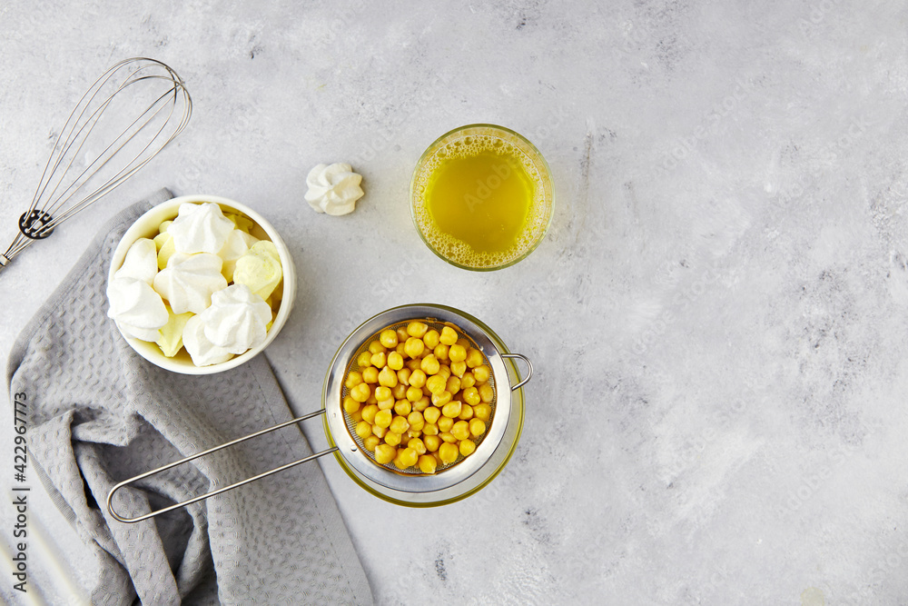 Chickpea brine, aquafaba and prepared meringue. Egg replacement for vegan recipe. Healthy vegan product. Top view. Copy space. Chickpea brine, aquafaba and prepared meringue. Egg replacement for vegan recipe. Healthy vegan product. Top view. Copy space.