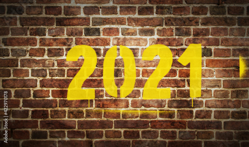 2021 year sign spray painted on the brick wall