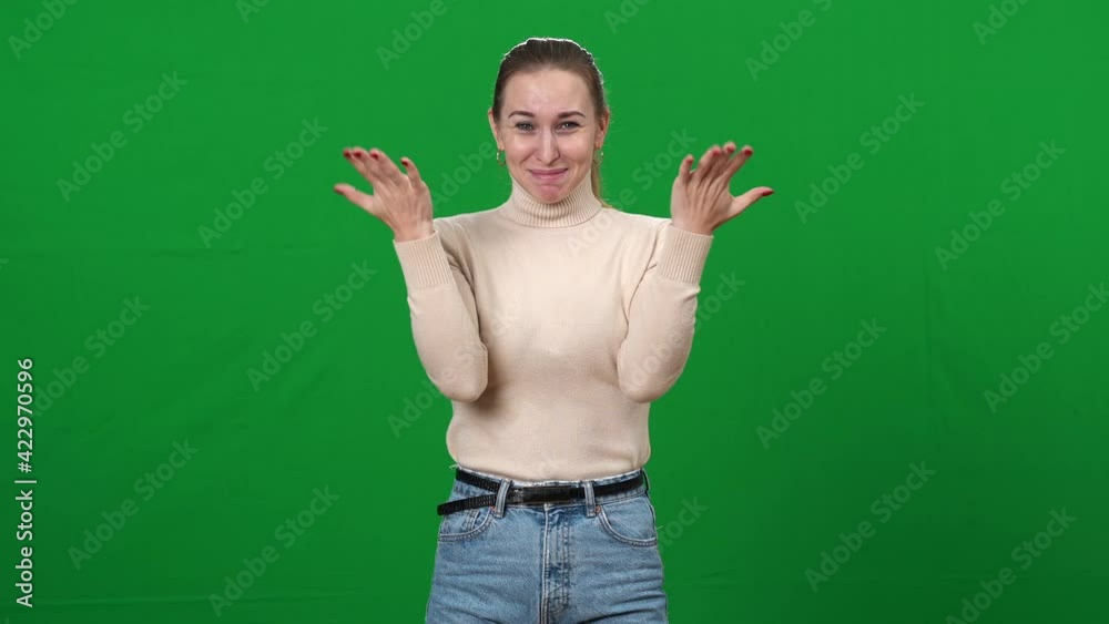 Reaction of excited young woman on green screen. Portrait of beautiful slim Caucasian lady shaking hands with tears of happiness on eyes. Chromakey background. Reaction of excited young woman on green screen. Portrait of beautiful slim Caucasian lady shaking hands with tears of happiness on eyes. Chromakey background.