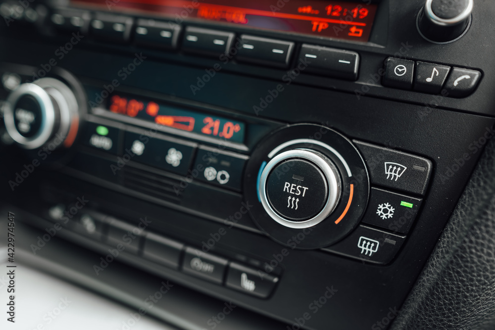 Car climate control panel with air conditioning on. The air conditioning system is ready for high summer temperatures Car climate control panel with air conditioning on. The air conditioning system is ready for high summer temperatures