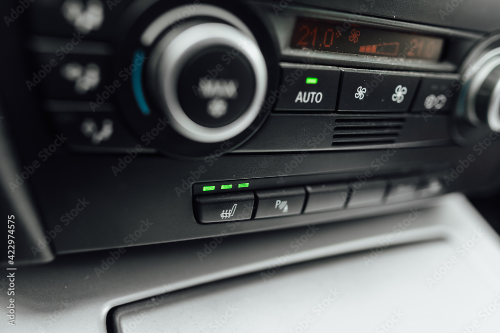 the climate control panel in a car with bench heating on has a visible level of interior heat