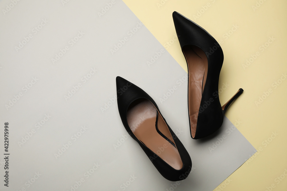Pair of elegant black high heel shoes on color background, flat lay. Space for text Pair of elegant black high heel shoes on color background, flat lay. Space for text