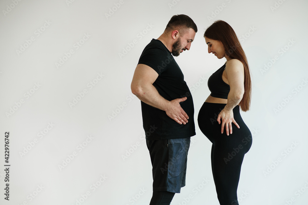 Husband and pregnant wife doing sports Husband and pregnant wife doing sports