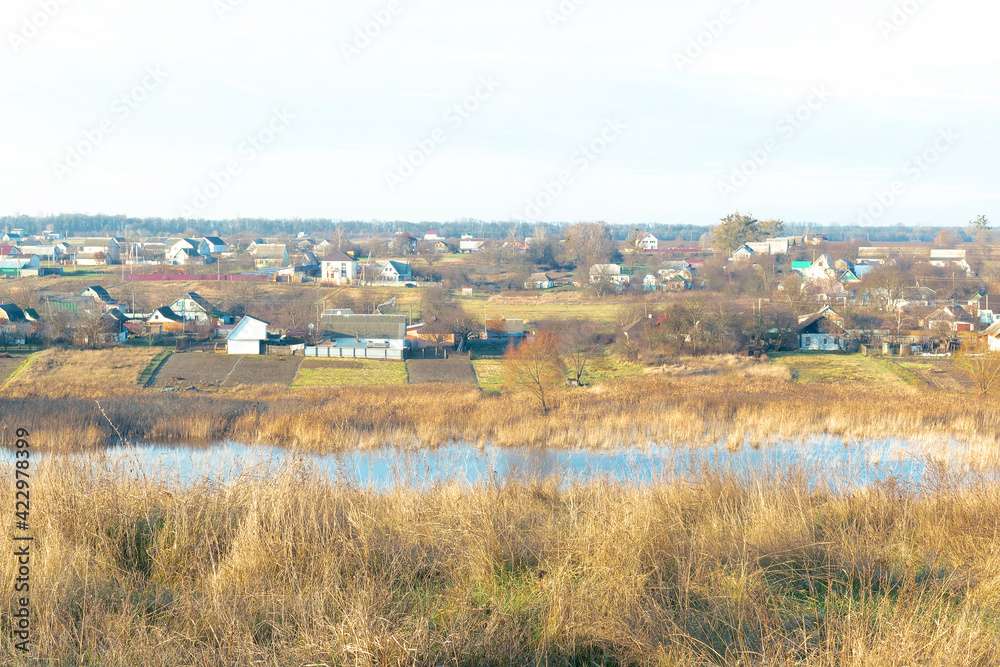 Aerial photo over rural old village surrounded by green orange countryside, lake, old houses, nature spring landscape. Aerial photo over rural old village surrounded by green orange countryside, lake, old houses, nature spring landscape.