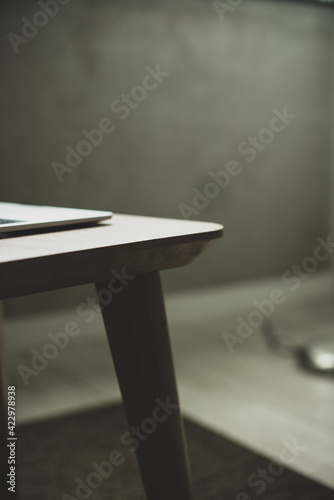 table and laptop on the grey background