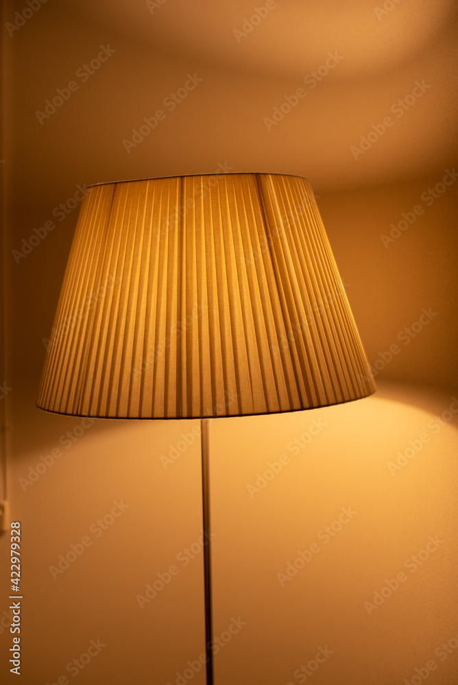 floor lamp with warm light and reflection in the window floor lamp with warm light and reflection in the window