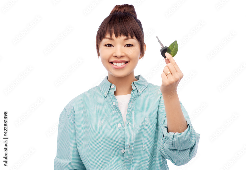 happy asian woman holding car key with green leaf happy asian woman holding car key with green leaf