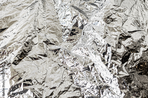 Background texture of crumpled foil. Flat lay. Copy space. Horizontal