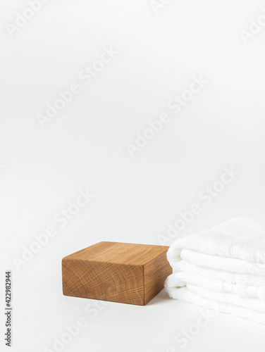 Fototapeta Naklejka Na Ścianę i Meble -  Empty wood cube podium for products presentation. Display stand and white towel