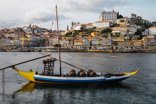 Typical boat in Porto, Portugal old town skyline from across the Douro River.
