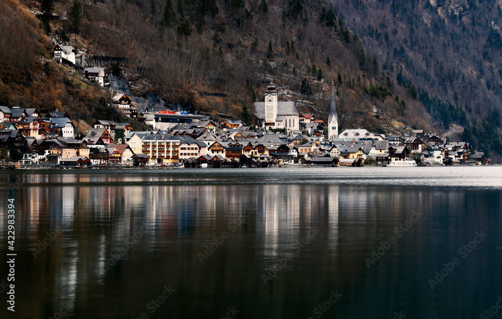 View of Hallstatt, traditional austrian village, reflection on the lake