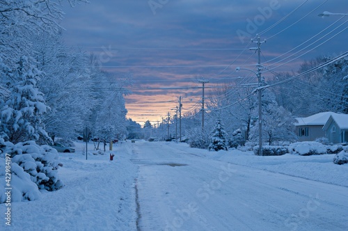 Snow covered road way sunrise