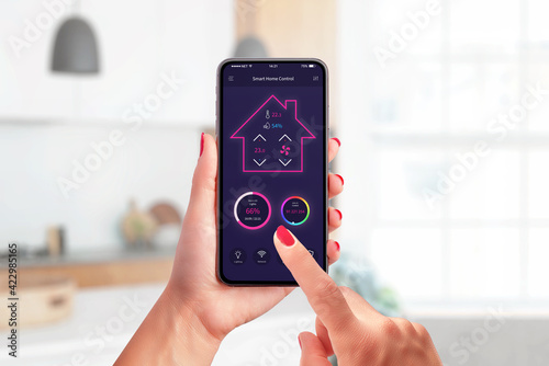 Smart home control app concept on modern phone in woman hands