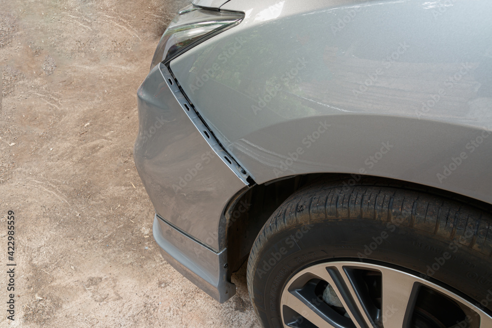 Car crash or accident. Front fender and light damage on bumper. Broken vehicle detail of Private car , close up.