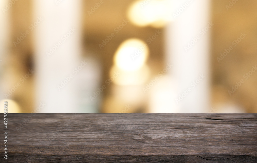 Empty wooden table in front of abstract blurred background of coffee shop . can be used for display or montage your products.Mock up for display of product Empty wooden table in front of abstract blurred background of coffee shop . can be used for display or montage your products.Mock up for display of product