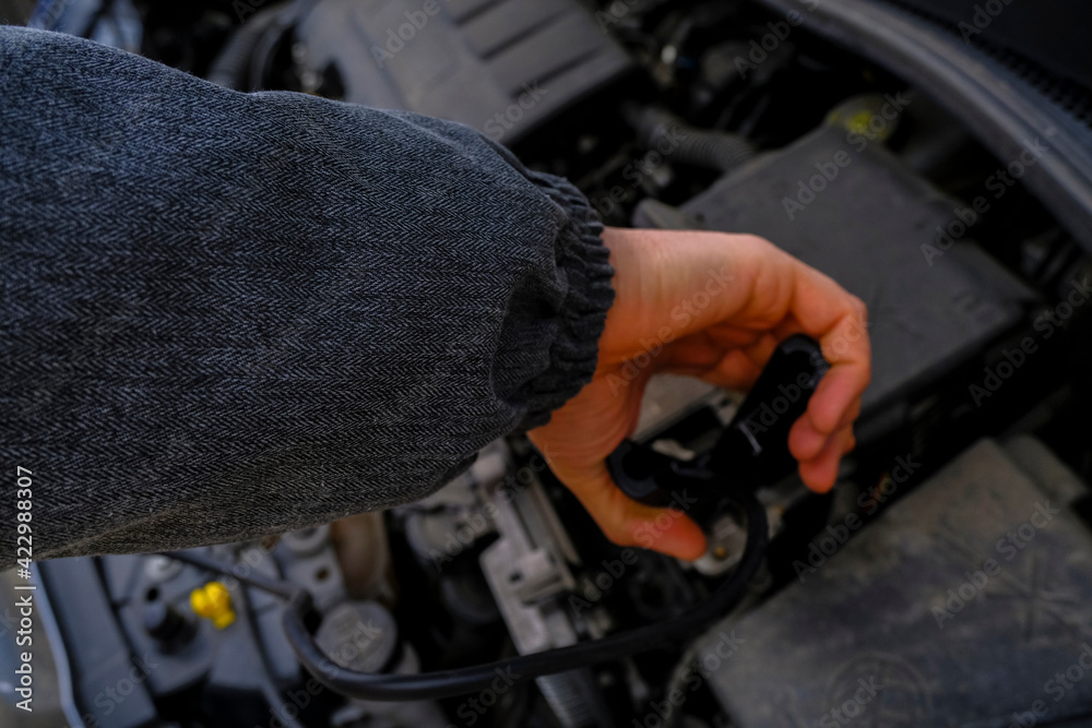 mechanic working on a car close-up. Open hood at service station close-up. Car open bonnet top view mechanic working on a car close-up. Open hood at service station close-up. Car open bonnet top view