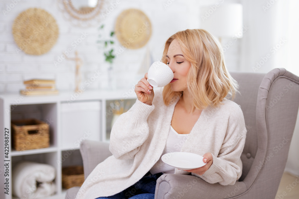 morning and breakfast concept - happy young woman drinking coffee at home. morning and breakfast concept - happy young woman drinking coffee at home.