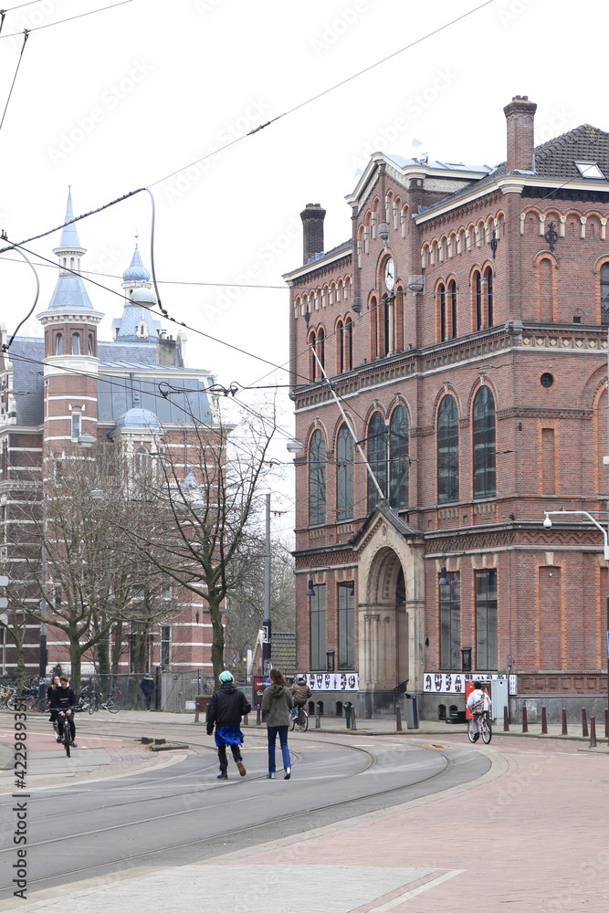 Amsterdam Street View with Paradiso Building, Tram Cables and People