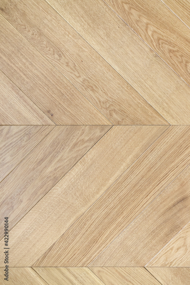Top view of an french herringbone parquet floor under natural light. Wooden pattern with oak diagonal texture. - obrazy, fototapety, plakaty 