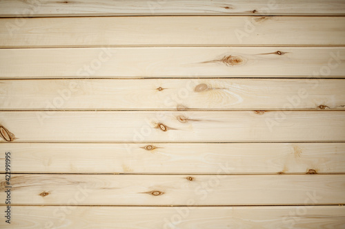The background is a wall made of wooden beams.Texture for your design. Wooden beam and board. Background for still life. Beautiful wood texture. 